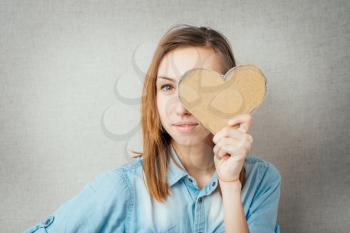 girl holding a cardboard paper heart