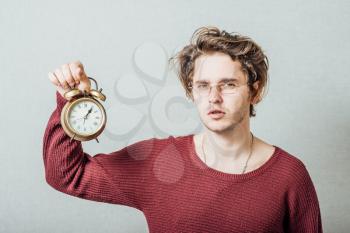 man holding an alarm clock in hands