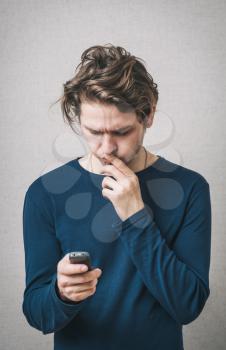 man looking scared into the mobile phone