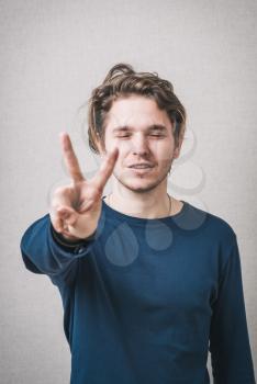 man showing two fingers