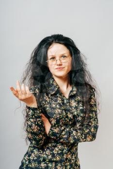 long-haired woman points finger, teacher