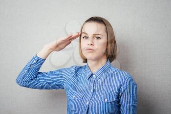 Attractive business woman saluting.