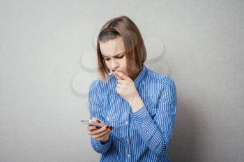 girl looking at mobile and thinks
