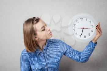 woman looks at the clock