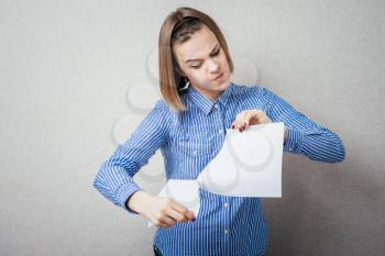 girl tearing the paper into small pieces