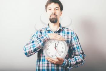 Businessman holding large clock