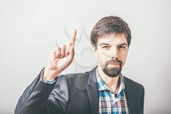 man shows his index finger up