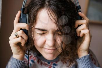 emotional girl listening to music on headphones