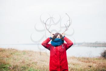 woman with antlers is smiling
