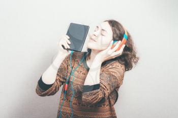 woman in headphones and a tablet