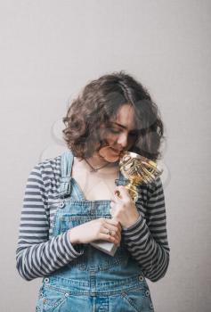 young girl holding a prize cup and happy