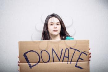 Pretty girl holding a sign donate