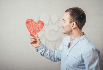 young man holding a heart