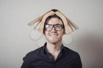 man with a book on his head
