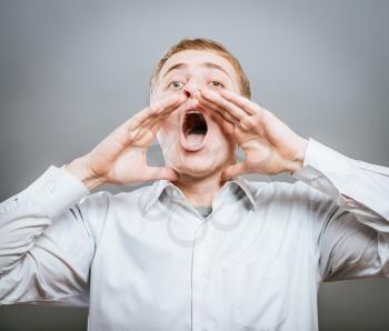 Photo of shouting man with his palms open by mouth looking upwards