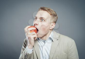 hungry man eating a fresh apple. 
