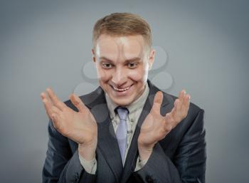 young businessman in shock with hands at sides