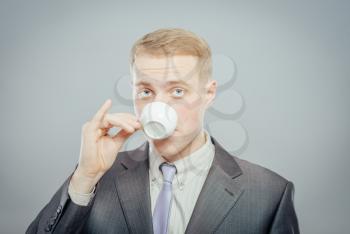 Close up of a handsome businessman drinking tea