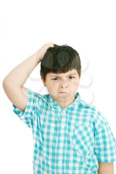 Boy scratches his head in puzzlement or confusion, as if pondering a deep question. Over white background. 
