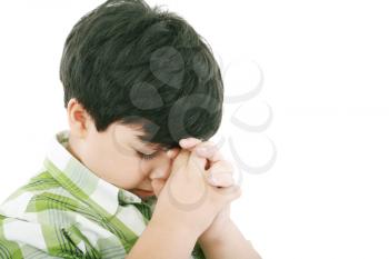 A boys prays earnestly to his creator in heaven 
