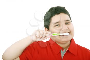Beautiful boy brushing teeth, isolated on white 
