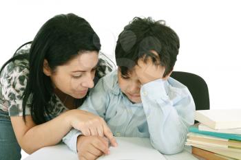 mother helping with homework to her son indoor 
