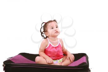 cute little girl sitting on the black suitcase 
