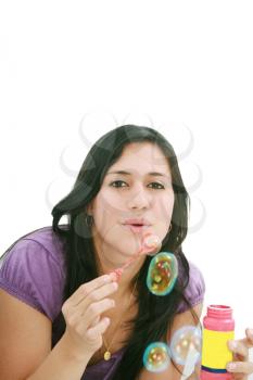 Young woman portrait making soap bubbles. 

