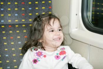 Cute little girl looking window inside a moving train