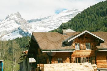 Lovely Swiss chalet with mountains in background 
