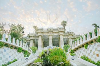 Pavilion decorated with mosaic in Park Guell starting the sunset, Barcelona