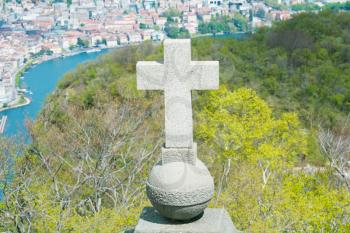 View of Lugano from San Salvatore mountain with a cross in front 
