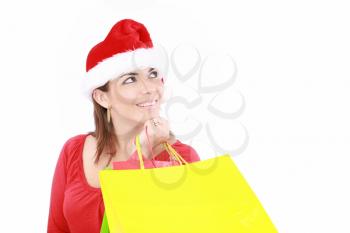 Attractive woman in Christmas cap hands packets, isolated on white