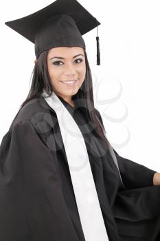 Female graduate wearing a gown and mortarboard - isolated over white 

