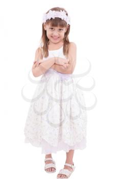 Full length portrait of a little girl standing with folded hands over white background 