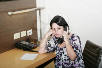 businesswoman having boring call in office