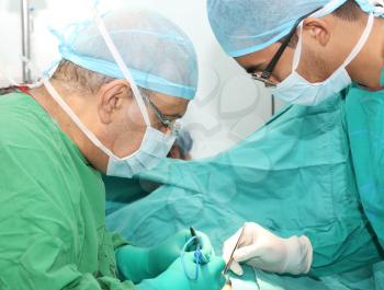 Surgeons working on a patient in operation room