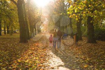 Royalty Free Photo of a Family Walking Through a Park