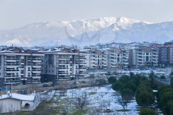 Royalty Free Photo of Buildings by Mountains