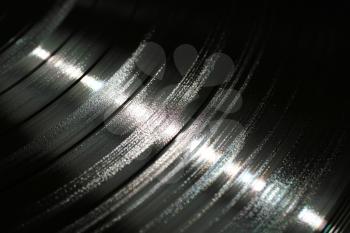 Segment of vinyl record showing the texture of the grooves