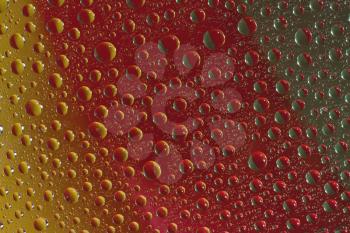 Royalty Free Photo of a Closeup of a Dewy Colorful Glass Surface