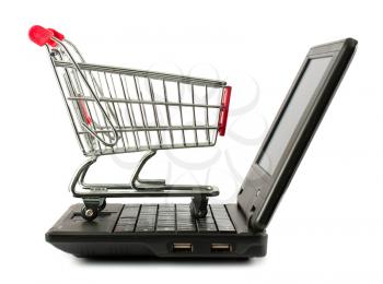 Royalty Free Photo of a Shopping Cart Sitting on a Keyboard of a Laptop Computer