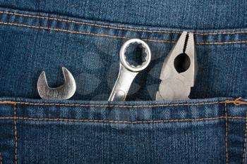 Royalty Free Photo of Pliers and Wrenches in the Pocket of Denim Jeans