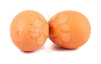 Two brown chicken eggs isolated on white