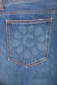 Empty back pocket of blue jeans. Denim texture background.