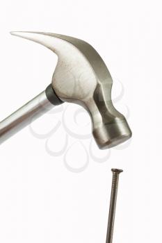 Hammer and nail closeup isolated over white background