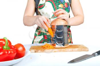 Royalty Free Photo of a Woman Grating a Carrot