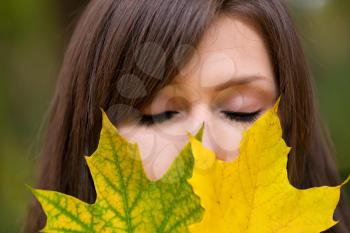 Royalty Free Photo of a Woman Holding Leaves