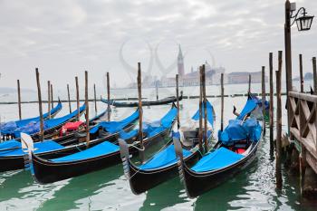 Royalty Free Photo of Gondolas at a Pier in Venice
