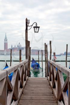 Royalty Free Photo of a Gondola at a Pier in Venice